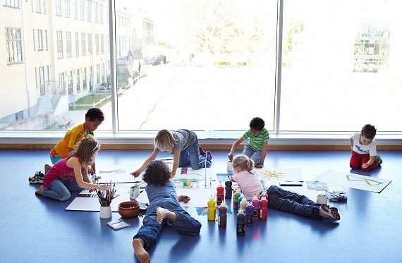 picture of children creating posters on the floor