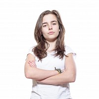 teenager standing up with their arms folded