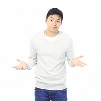 teenager standing in a shrug pose
