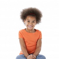 Young child sitting cross legged and smiling