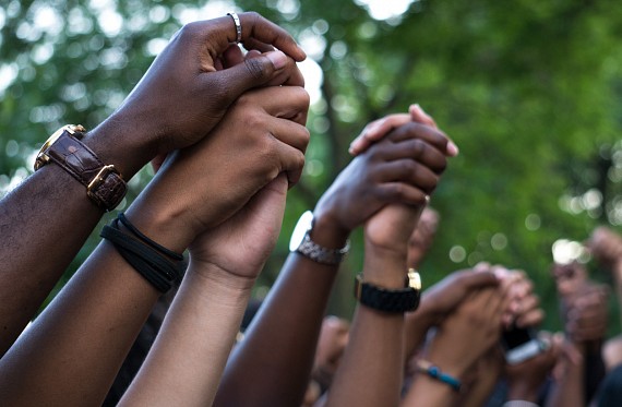 black lives matter protesters holding hands