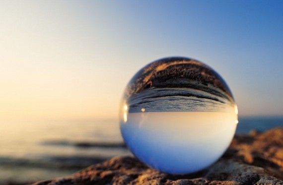 reflective glass ball on beach to represent internal reflection