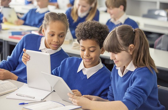 Small group of children talking in class