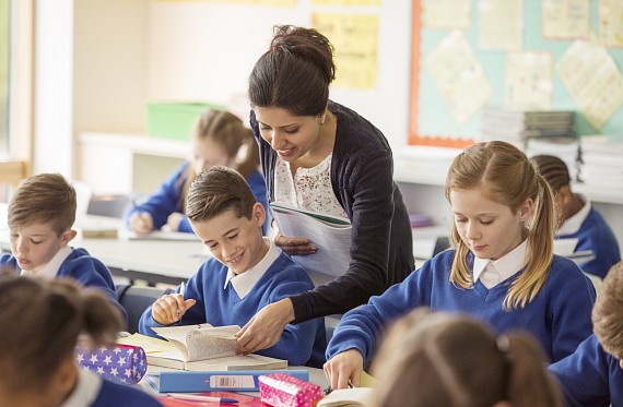 Teacher in classroom with pupils