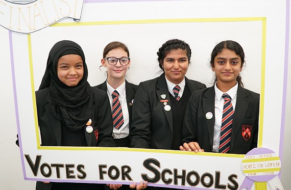Students holding VotesforSchools banner