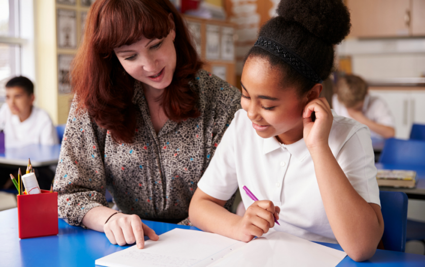 key stage 2 pupil learning with teacher