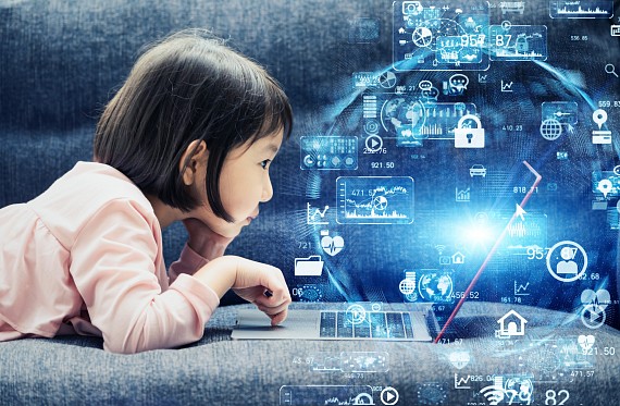 Young girl looks at computer