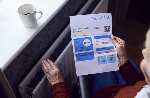 elderly person looking at energy bill