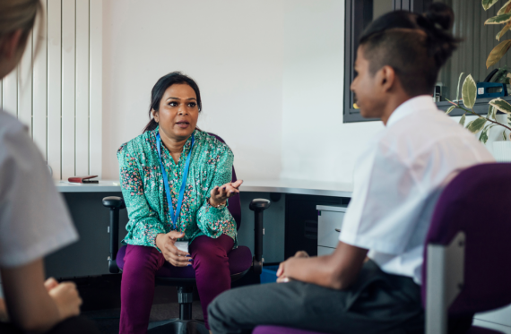 A pupil talking with adults