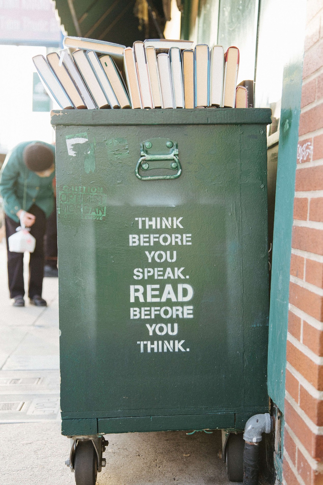 spraypainted bookshelf with think before you speak read before you think written on it