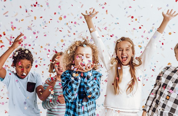 children celebrating with confetti