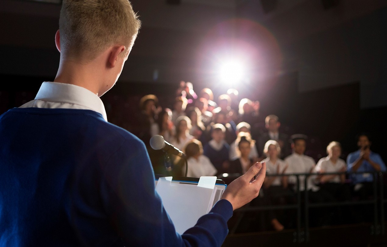 boy giving a presentation in assembly